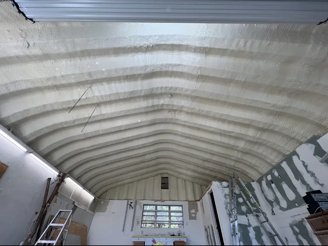 Spray polyurethane foam applied to the underside of a metal roof deck in Schertz